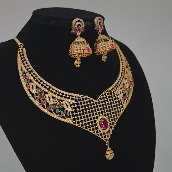 Gold-Plated Designer Net Necklace Set with Ruby, Emerald, and White CZ Stones – Bridal Jewelry with Jhumkas for Weddings & Special Occasions
