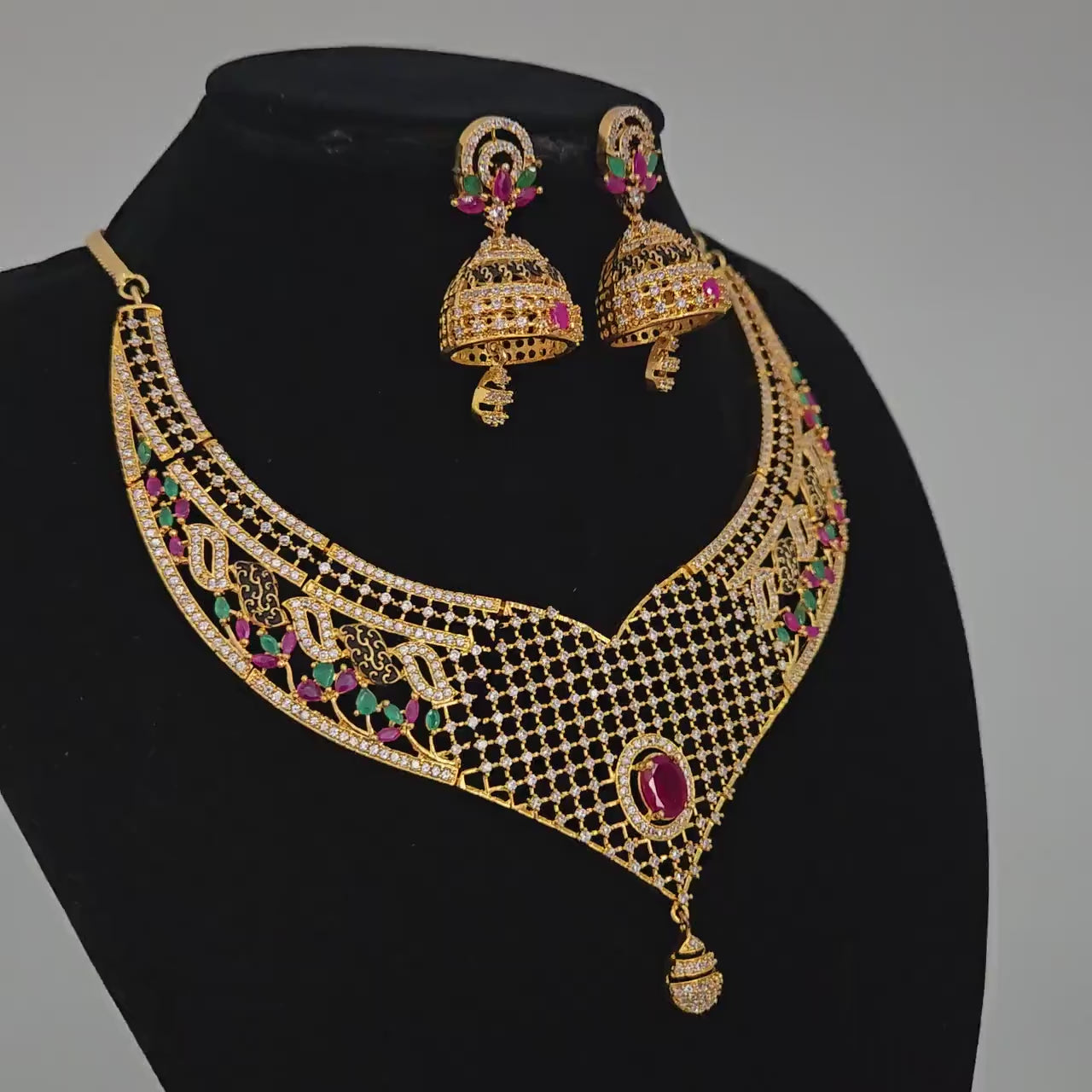 Gold-Plated Designer Net Necklace Set with Ruby, Emerald, and White CZ Stones – Bridal Jewelry with Jhumkas for Weddings & Special Occasions