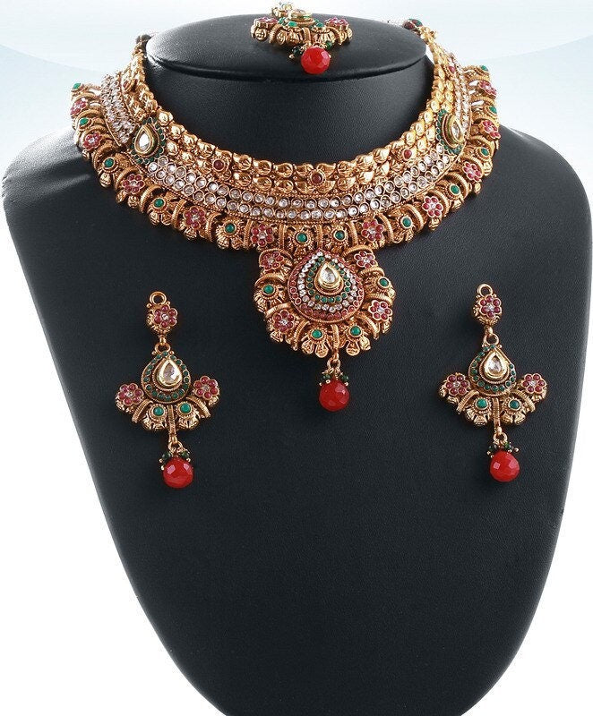 Studded designer elegant polki bridal jewelry set in golden background with Emerald,ruby and white stones