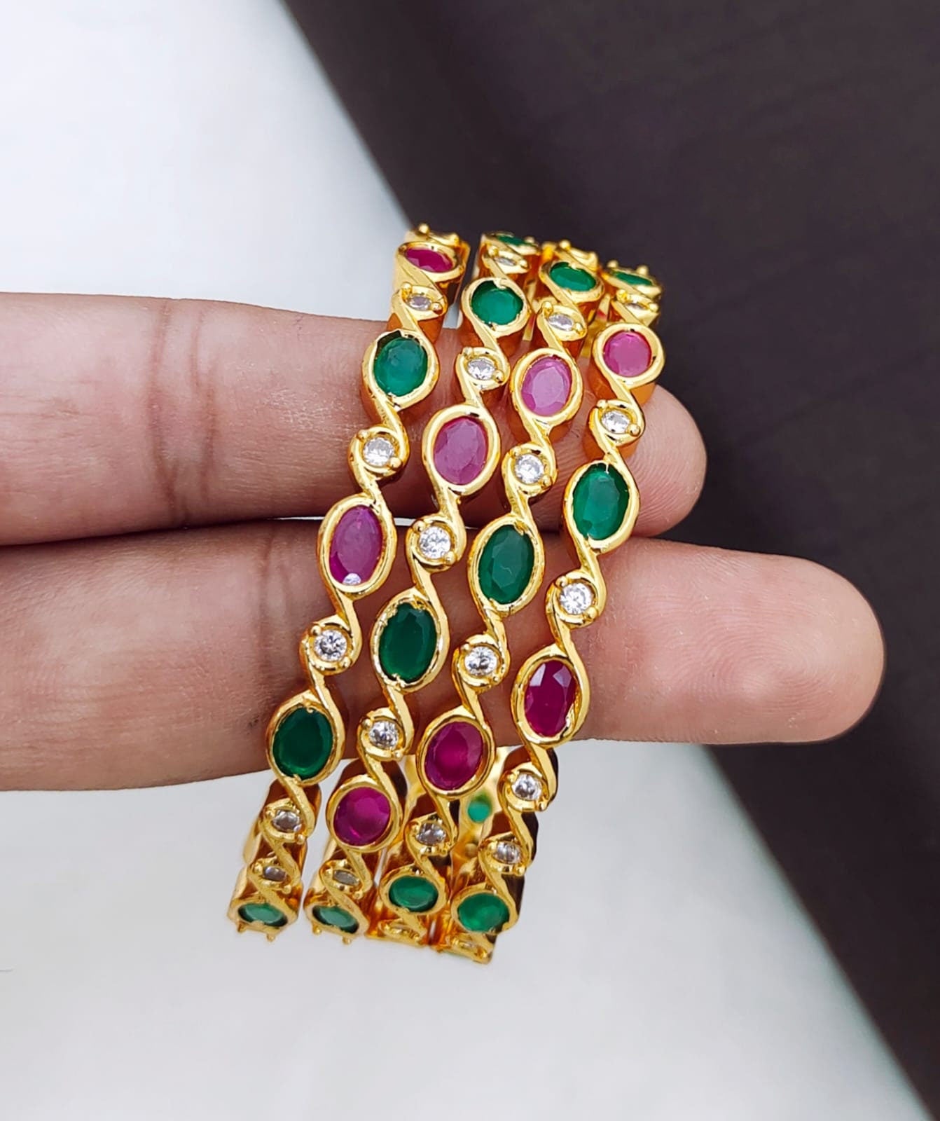 Gold polish Designer bangles studded with round Cz AD ruby stones